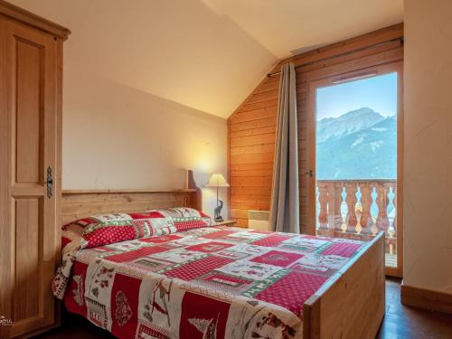 a bedroom with a bed and a large window at Chalet Pra-Loup, 4 pièces, 10 personnes - FR-1-165A-47 in Uvernet