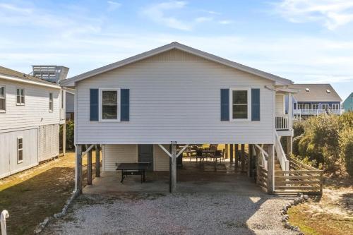 a house with a wrap around porch at Dunebug Cottage 319 Sandpiper Lane home in Holden Beach