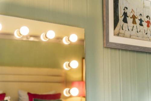 a room with a mirror and a picture on the wall at Royal View Apartments in Kirkby Lonsdale