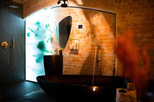 a bathroom with a bath tub and a mirror at World Studio Sibiu in Sibiu