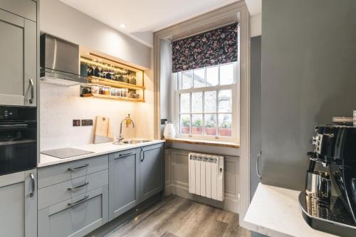 a kitchen with a sink and a window at Royal View Apartments in Kirkby Lonsdale