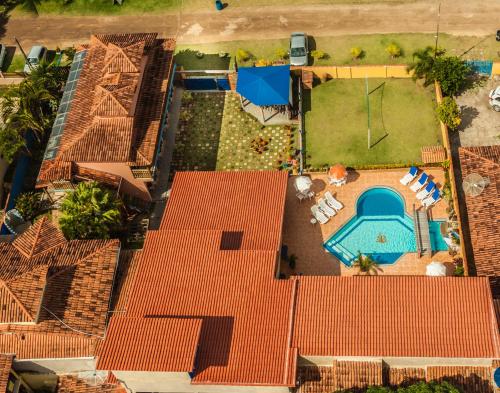 an overhead view of a house with a swimming pool at Pousada dos Corais in Itaúnas