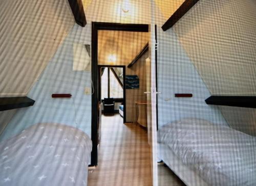 um quarto com duas camas e um corredor em Vosseven69 em Stramproy