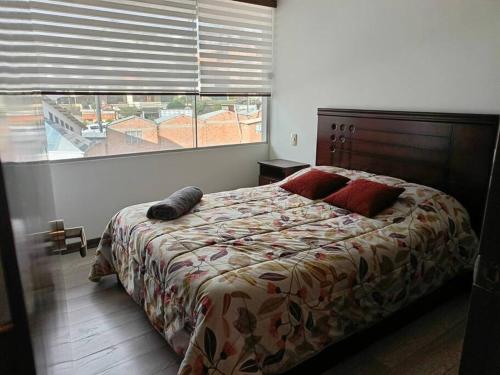 a bedroom with a bed and a large window at Tranquilo 1D,excelente ubicación. Cala Coto in La Paz