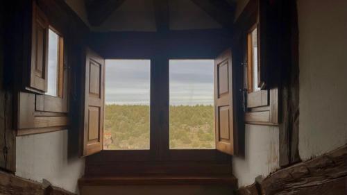 an empty room with a window with a view at Las Tongueras in Pedraza-Segovia