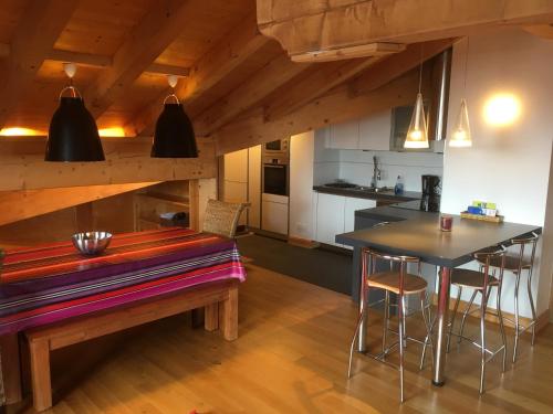 a kitchen and dining room with a table and chairs at les 7 laux immobilier chalet C in Prapoutel