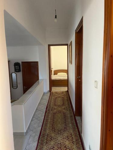 a hallway with a room with a bed in the distance at Trikala Comfort Stay in Tríkala