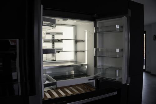 an empty refrigerator with its door open with a window at Ferienhaus in Lüneburg in Westergellersen