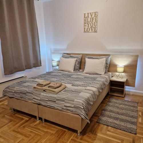 a bedroom with a bed with two towels on it at Apartment Mavero-Free Private Parking in Zagreb
