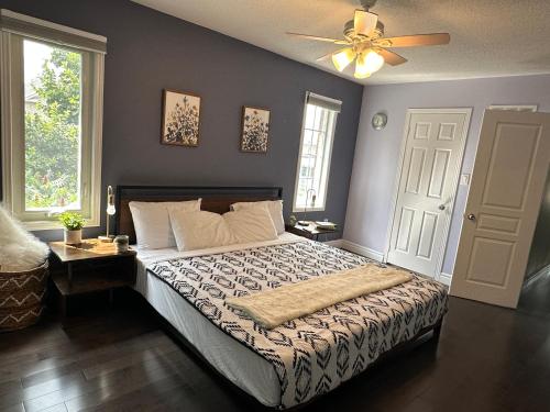 a bedroom with a bed and a ceiling fan at Chic, Spacious Home You'll Love in Markham