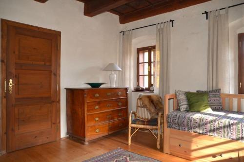 a bedroom with a bed and a dresser and a window at Vejminek Hynčina 