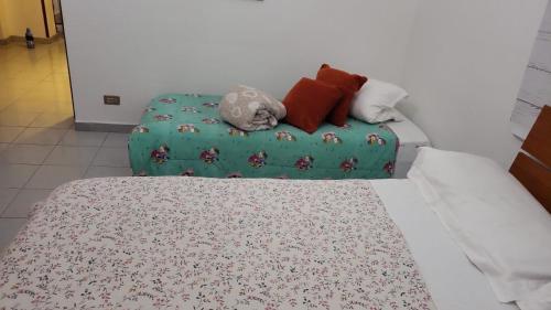 a bed with several pillows on top of it at Casa bea in Taranto