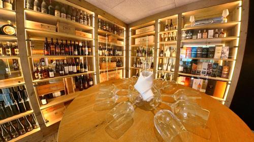 a large wooden table in a room with bottles of wine at Feuriger Tatzlwurm Berghotel & Spa, BW Signature Collection in Oberaudorf