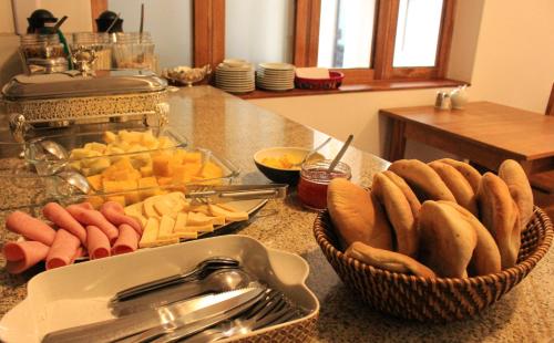 a counter top with a bowl of bread and a basket of food at Akilpo Home in Huaraz