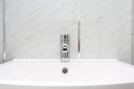 a white sink with a faucet on top of it at Edinburgh Apartment near University of Edinburgh - Elforma in Edinburgh