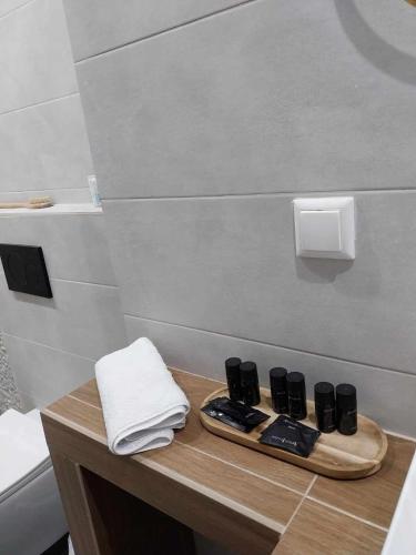 a bathroom with a counter with a sink and a towel at Galazio Seaside Luxury Rooms & Coffee Shop in Platamonas