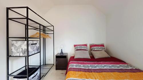 a bedroom with a bed and a book shelf at Appartement pro uniquement pas touristes ou familles in Stains