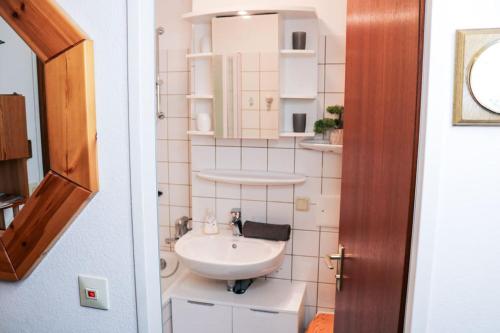 a small bathroom with a sink and a toilet at Schluchseezauber 1123 - Alm Chic mit Pool & Sauna in Schluchsee