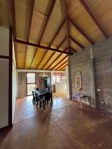 a large room with a table and chairs in it at Casa Campestre Lago Calima in Calima
