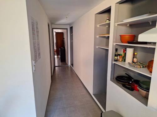 a hallway leading to a kitchen with a hallway at Agréable Studio tout équipé in Montsoué