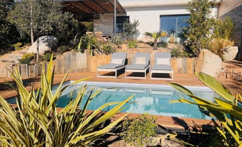 une arrière-cour avec une piscine et deux chaises longues dans l'établissement Un petit paradis, à Pinarellu