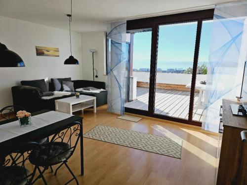 a living room with a view of a large window at Seeblick in Daisendorf