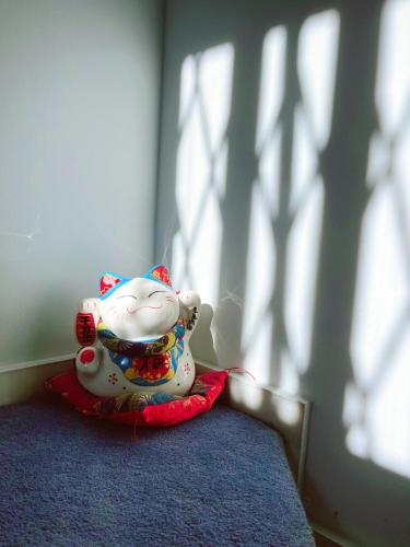 a small ceramic cat figurine sitting on a table at nicole's home in Athens