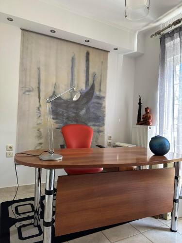 a desk with a lamp on it in a room at Villa Ariadni in Patra