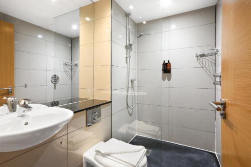a bathroom with a sink and a shower at BeiRoom Hyde Park Apartments in London