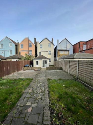 an empty driveway in front of a group of houses at Citrine - Executive London Garden Flat in South Norwood