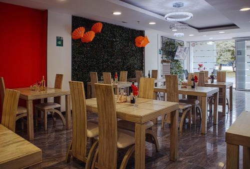 a dining room with wooden tables and chairs at Hotel Boutique Palacete in Bogotá