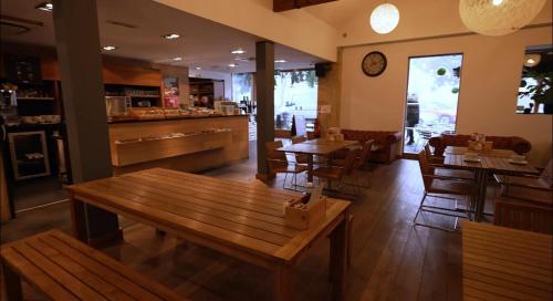 a restaurant with wooden tables and chairs and a counter at 57 The Meadows FallBarrow Park in Bowness-on-Windermere