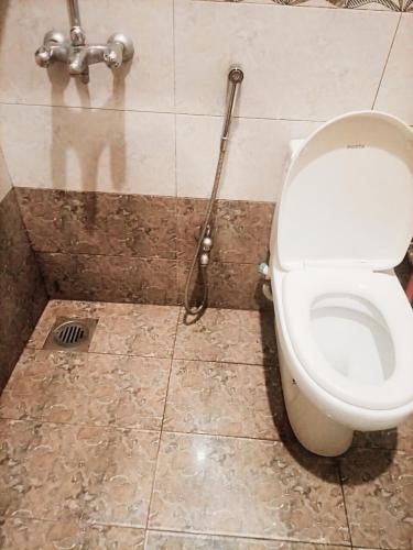 a bathroom with a toilet and a shower at Go Room Hotel Lahore in Lahore