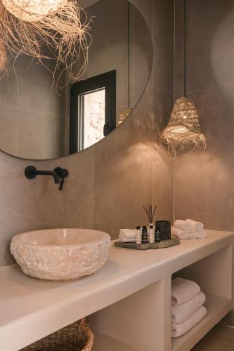 a bathroom with a sink and a mirror at Petra Tranquila Villa in Kefallonia