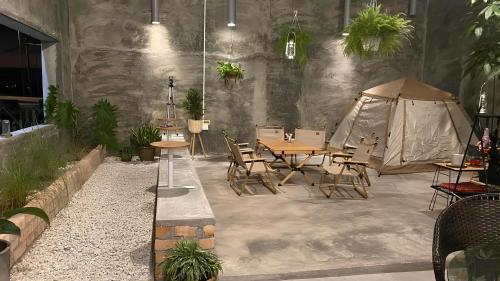 a patio with a table and chairs and a tent at MostPopular!!! Hay Cafe TranquilFields - OnlyYou with Hay, Rentable For Event in Sekincan