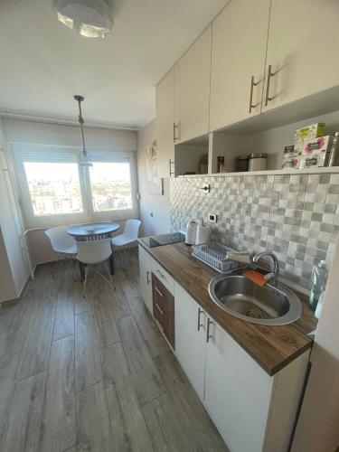 a kitchen with a sink and a table in it at Viewpoint in Belgrade