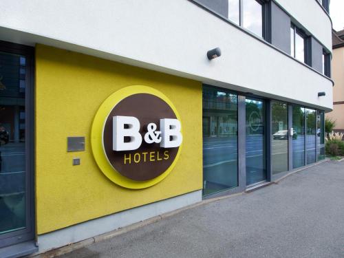 a yellow building with a b b hotels sign on it at B&B Hotel Würzburg in Würzburg