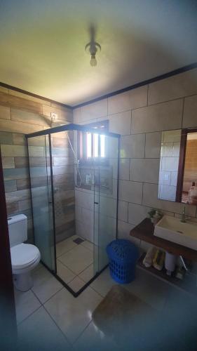 a bathroom with a shower and a toilet and a sink at Rancho 3 Guri in Osório