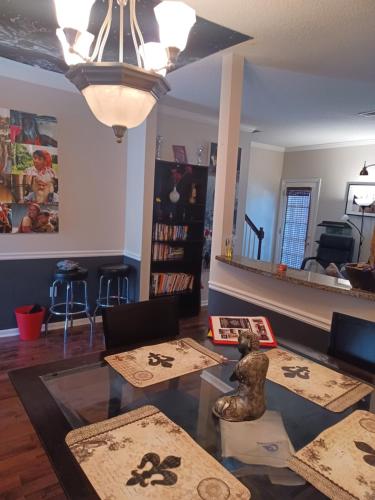 a living room with a glass table and chairs at Urban Adventure Townhome - Near Downtown Atlanta in Atlanta