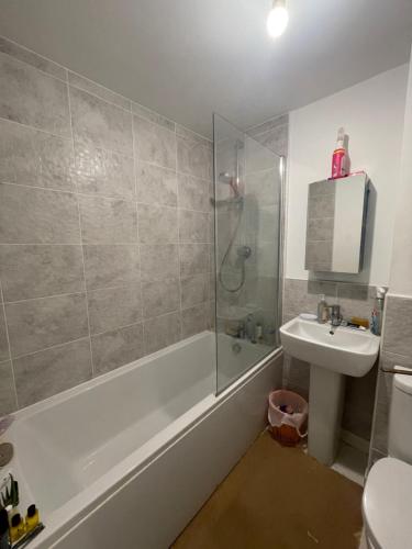 a bathroom with a tub and a sink and a shower at Chelmsford in Coventry