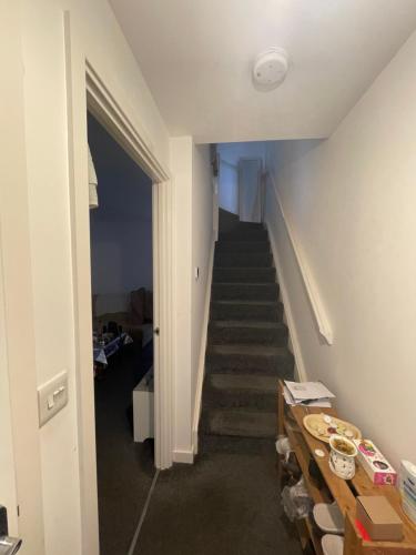a hallway with a stairway leading up to a room at Chelmsford in Coventry