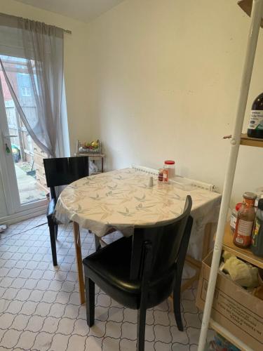 a table and chairs in a room with a table and a window at Chelmsford in Coventry