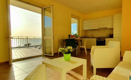 a kitchen and living room with a view of the ocean at Villa Theía apartaments sul mare in Montallegro