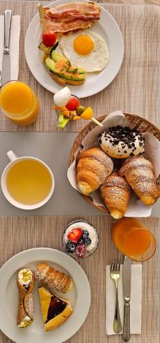 a table with plates of breakfast food on it at Hotel Mirage in Bellaria-Igea Marina