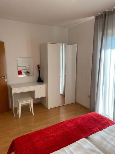 a bedroom with a bed and a desk and a red rug at Villa Jasmin in Bol