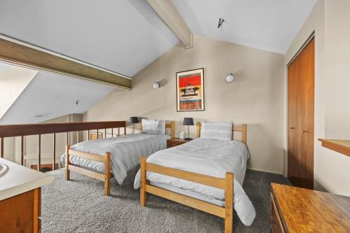 a bedroom with two beds and a table at Powder Pointe A-205 in Park City