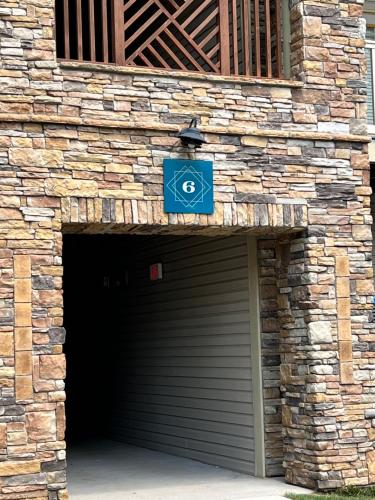 a garage with a blue sign on top of it at South Charlotte’s Cozy & Modern in Charlotte