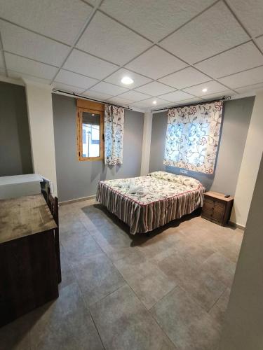 a bedroom with a bed in the middle of a room at Ca' La Conchin in Cortez de Pallas