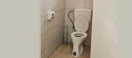 a bathroom with a toilet in a stall at Kapowlito Real Estate Casa #2 Mon Plaisirweg in Paramaribo