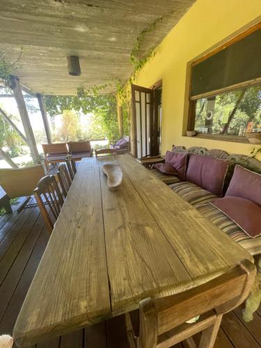 a wooden table in a living room with a couch at Hale Lau in José Ignacio